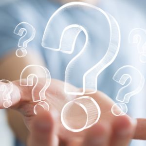 businessman-on-blurred-background-holding-hand-drawn-question-marks - Savannah Endocrinology - Savannah, GA.