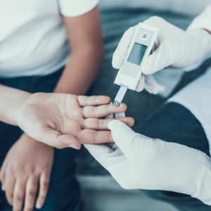 Doctor Taking Blood Sample from Boy's Finger - Savannah Endocrinology - Savannah, GA